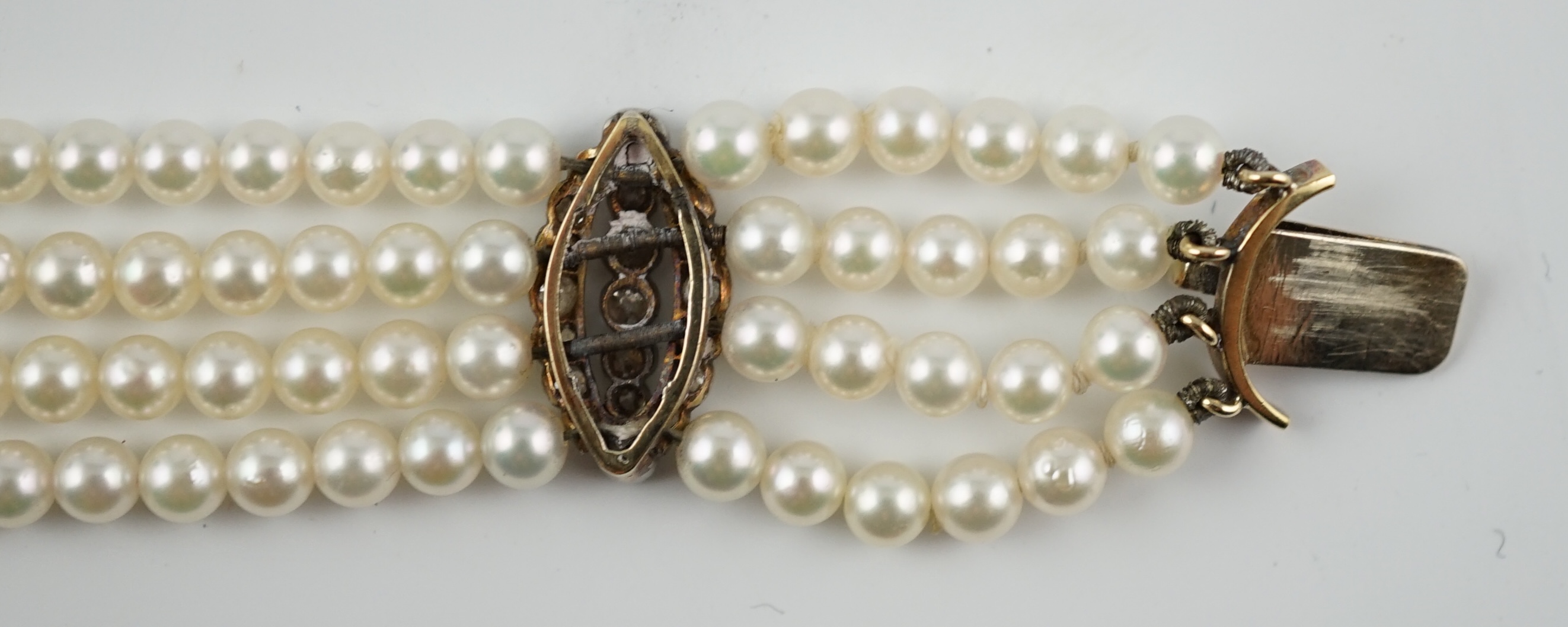 A multi-strand cultured pearl bracelet, with circular diamond cluster set gold clasp